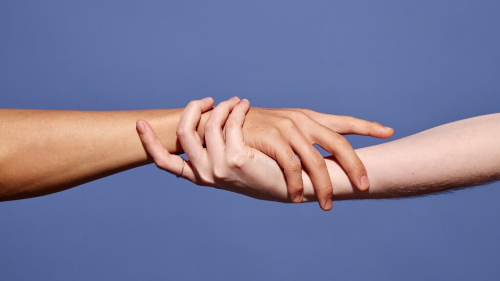 This image shows Embracing Hands Showcasing Unity and Connection - attachment styles in relationships
